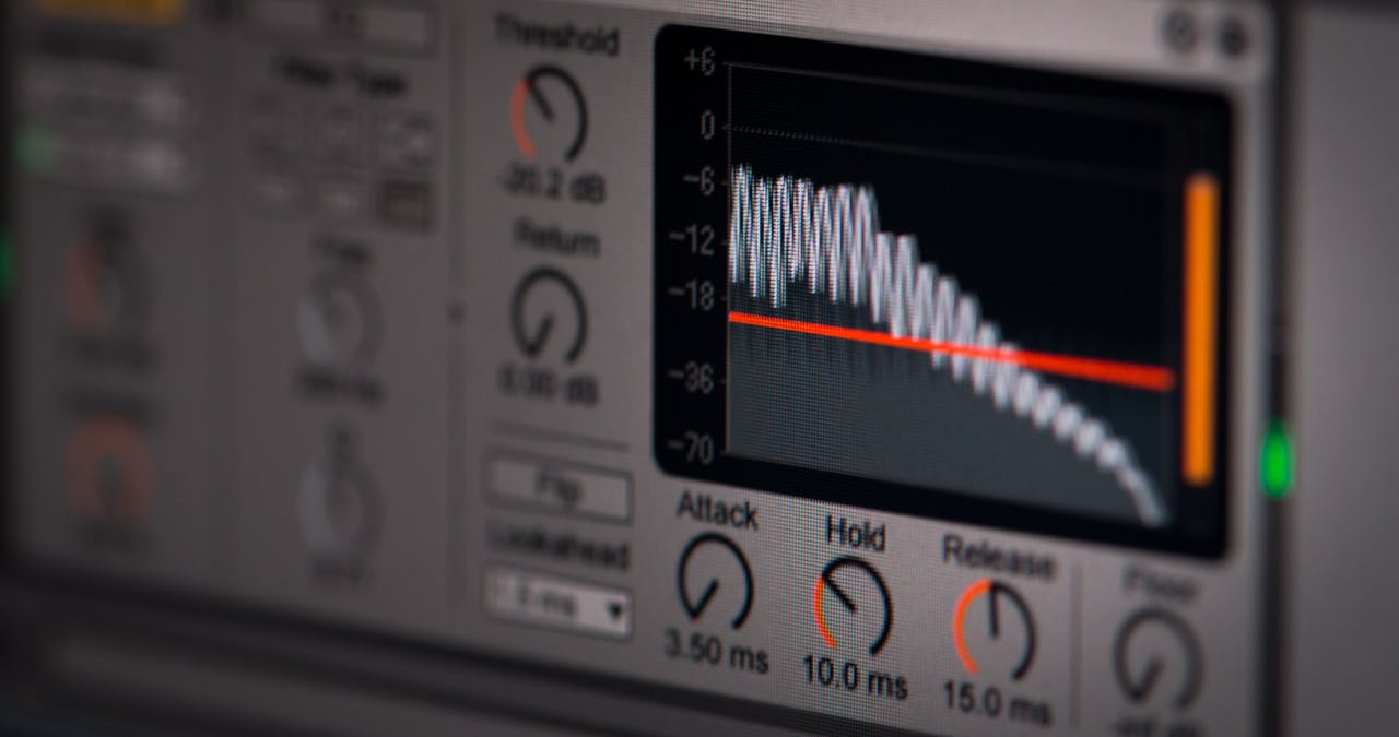 Close-up of audio editing software interface featuring waveform and controls.